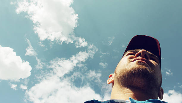 The man on the sky background - view from below