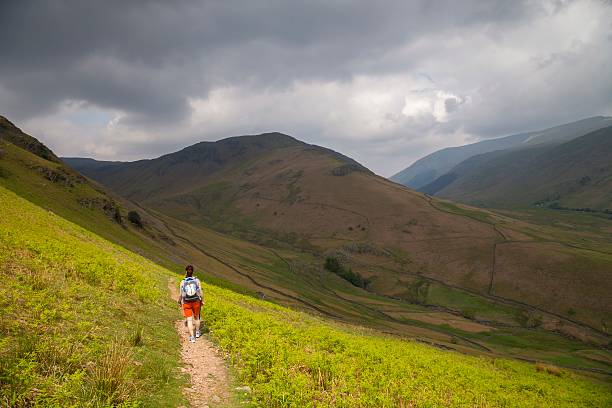 istock Lady walking down Helm Crag, Lake District, Cumbria, England 540974688