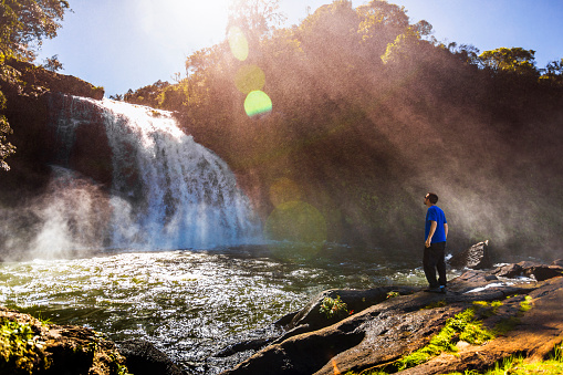 Man at waterfall.