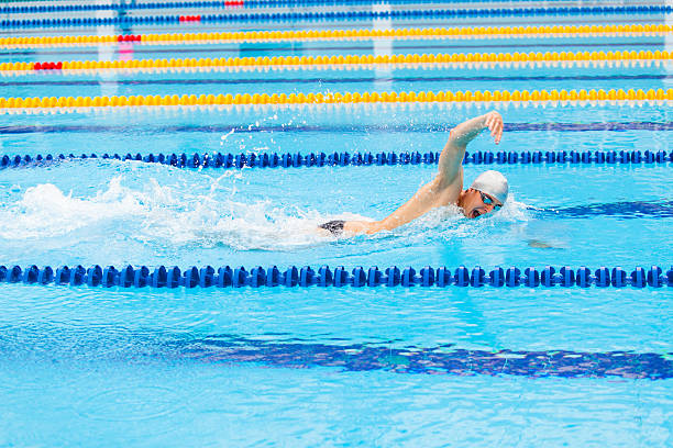 istock Man swimmer swimming crawl in blue water. 540975364