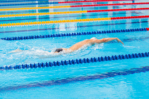 istock Man swimmer swimming crawl in blue water. 540975686
