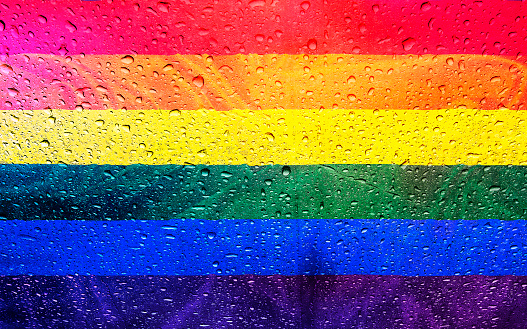 Rainbow flag of lbgt community with water drops