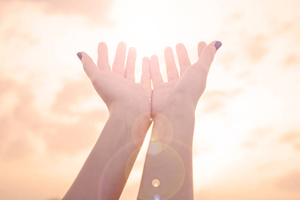 istock Female hands Reaching the sun with lens flare 540981488