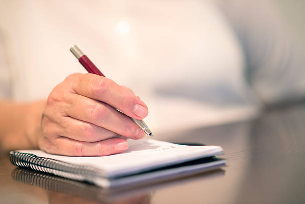 istock Closeup of woman's hand writing on paper 540981788