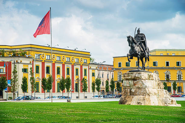Albania Skanderbeg Square Tirana Skanderbeg Monument and Albanian Flag at Skanderbeg Square - Sheshi Skënderbej. Tirana, Albania- albania stock pictures, royalty-free photos & images
