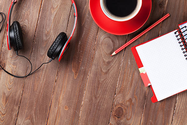 istock Desk with notepad, coffee and headphones 540982708