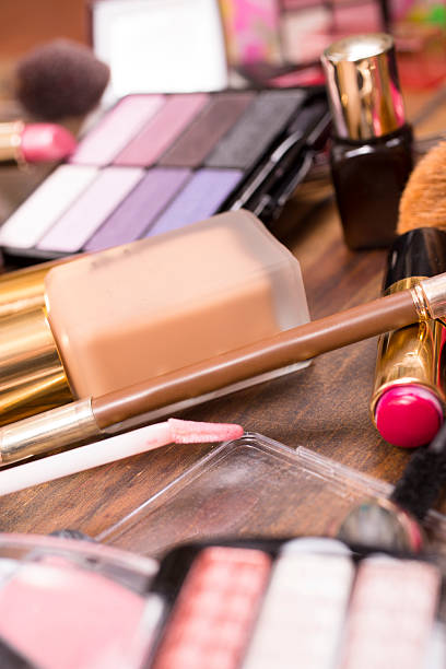 istock Pile of various cosmetics, make-up lie on wooden dressing table. 540984056