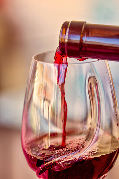 istock Pouring red wine in a glass 540984434