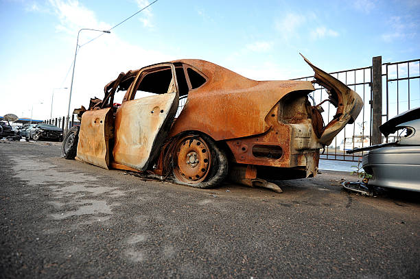 istock Wrecked and burning car on the road 540989672