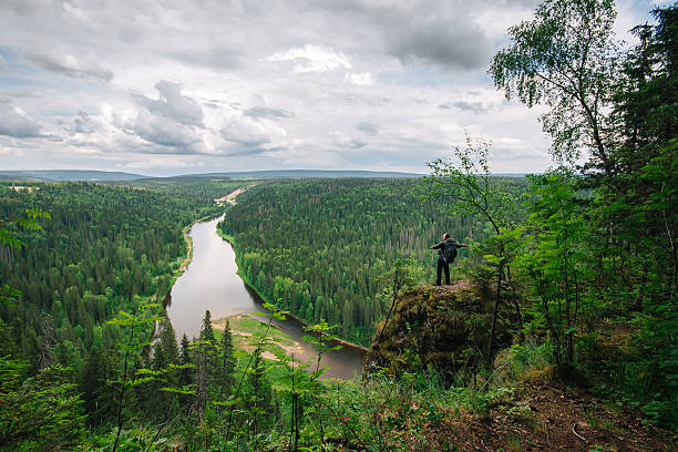 istock man with backpack stands on top of the mountain 540991154