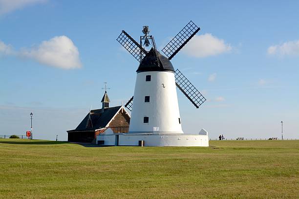 Lytham Windmill Lytham, United Kingdom - June 18, 2016: Lytham windmill on a sunny day sited at Lytham Green, 2 people can be seen in the distance, Lytham St Annes, Lancashire, UK lytham st. annes stock pictures, royalty-free photos & images