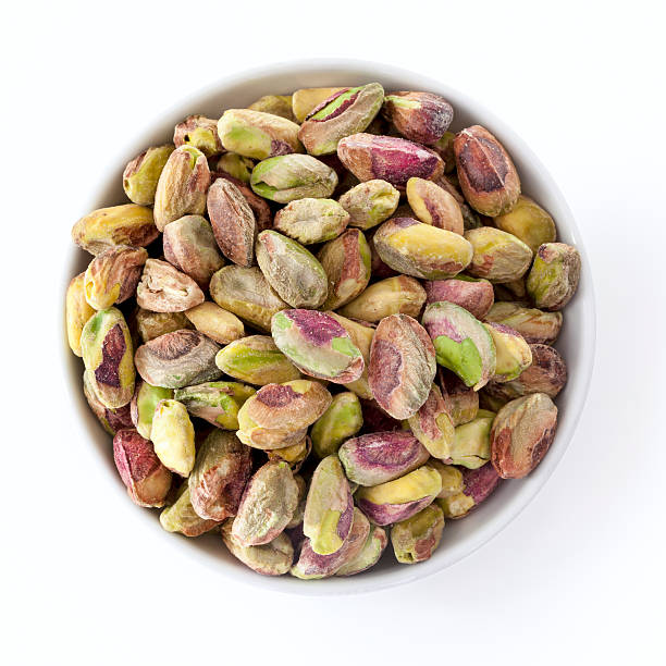 istock Dish of Shelled Pistachio Kernels Isolated on White Overhead Vie 540993692