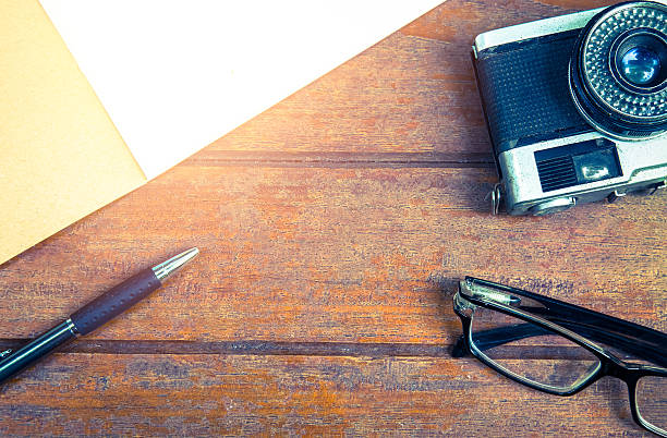 istock Overview desk of designer with notebook,glasses,pen and camera 540994922