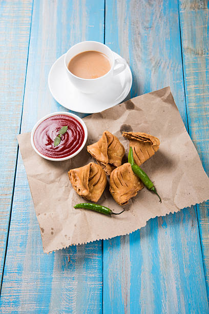 istock Samosa snack with tomato ketchup and hot tea 540994960