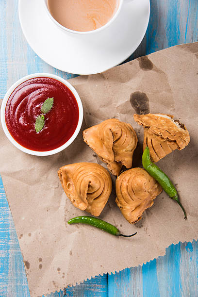 istock Samosa snack with tomato ketchup and hot tea 540995032