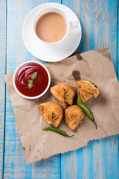 istock Samosa snack with tomato ketchup and hot tea 540995140