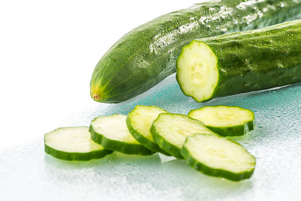 istock Fresh Cucumber slices on white background 540995580