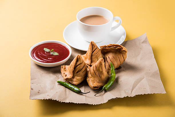 istock Samosa snack with tomato ketchup and hot tea 540995674