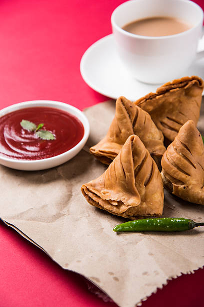 istock Samosa snack with tomato ketchup and hot tea 540995906