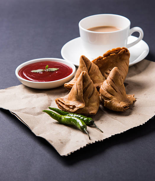 istock Samosa snack with tomato ketchup and hot tea 540996342