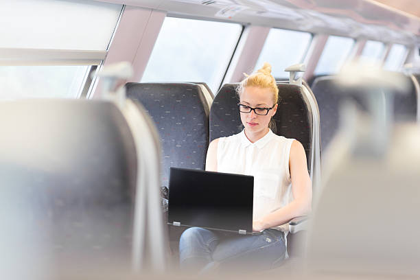istock Woman travelling by train working on laptop. 540996896
