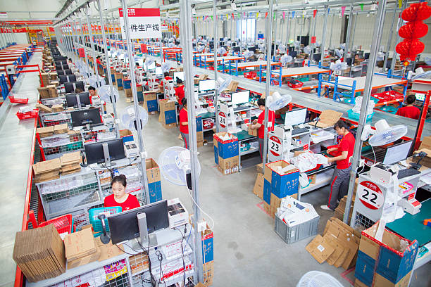 Gu'an, Сhina - June 14, 2016: JD.com staff receiving incoming goods, sorting products, and preparing shipments at the Northeast China based Gu'an warehouse and distribution facility