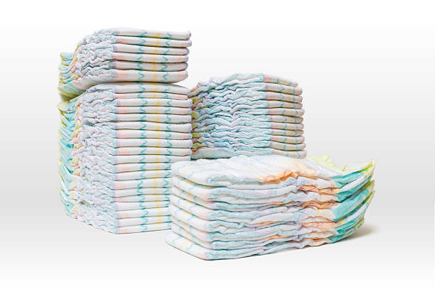 Stacked diapers isolated on white background. A lot of stacked diapers isolated on white background. Diaper stock pictures, royalty-free photos & images
