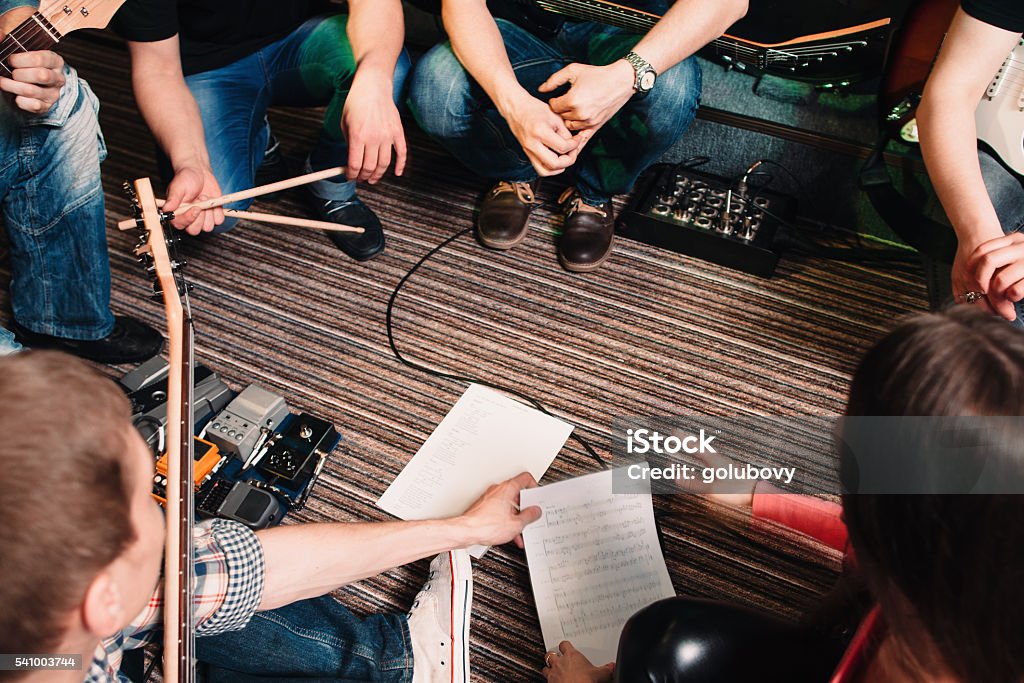 Musicians discussing new song top view Music Band Training Song Discussion Teamwork Cretivity Repetition Lifestyle Concept Backstage Stock Photo