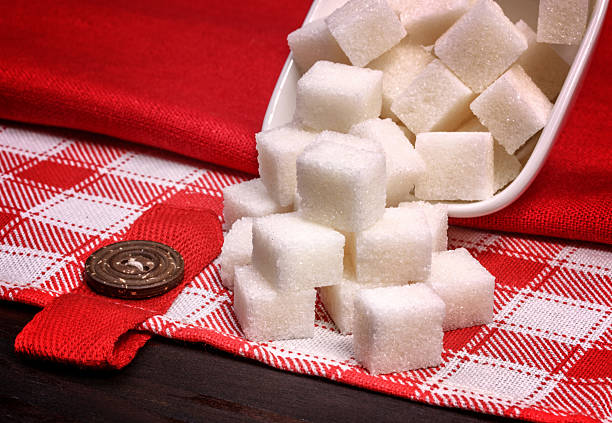 istock refined white sugar cubes on a red linen tablecloths 541005440