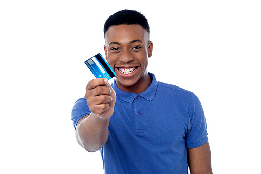 Smiling young boy showing credit card