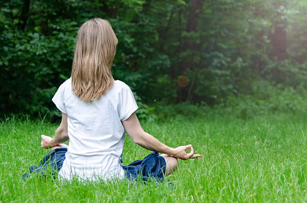 istock Woman doing yoga in the park 541006542