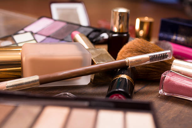 istock Pile of various cosmetics, make-up lie on wooden dressing table. 541007816