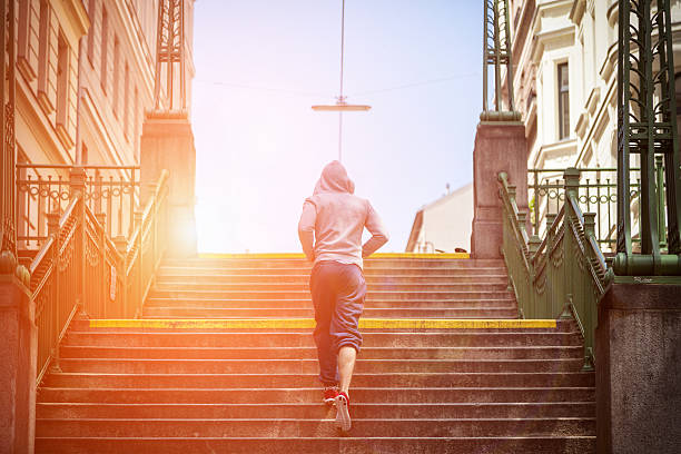 outdoor fitness concept in the city - determination running staircase jogging imagens e fotografias de stock