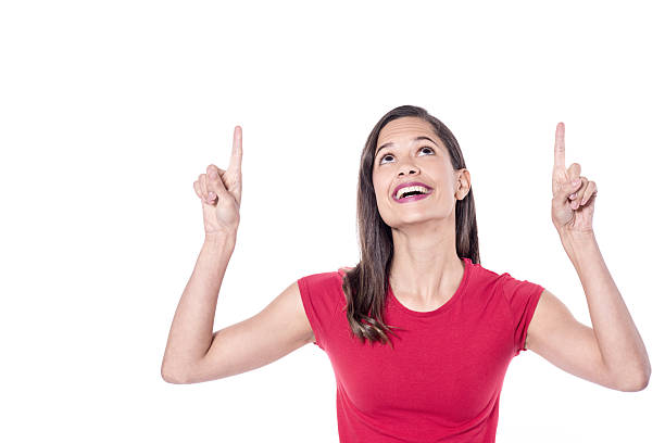 istock Smiling young woman pointing upwards 541111370