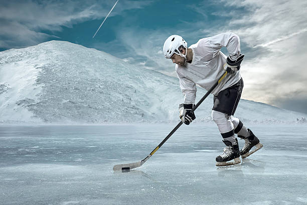 istock Ice hockey player on the ice in mountains 541115656