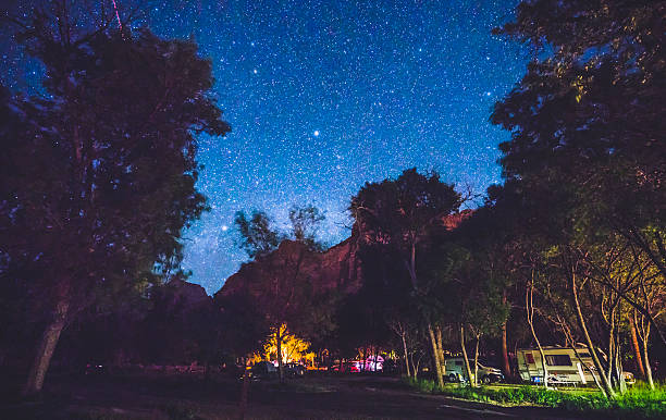 istock camping in campground area at night with star. 541116258