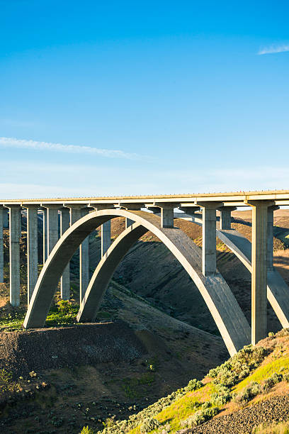 istock arc concrete bridge a cross the river when sunset. 541116634