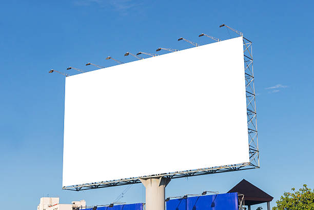 istock large blank billboard on road with city view background 541118018
