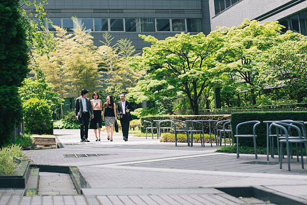 istock Business executives walking through office garden 541120144