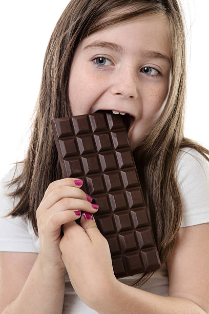 istock little girl eating chocolate 541120696