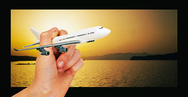 istock Child hand holding model airplane. Place for text. 541122256
