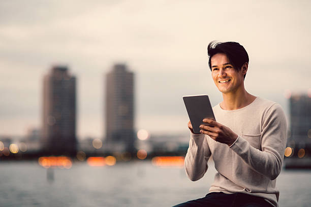 istock Young japanese man texting on the tablet 541122362