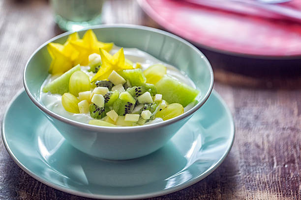 Yoghurt with Green Fruits Like Kiwi, Melon and Star Fruit Delicious Yoghurt with green fruits like kiwi, melon, apples and star star fruit served in a bowl. starfruit stock pictures, royalty-free photos & images