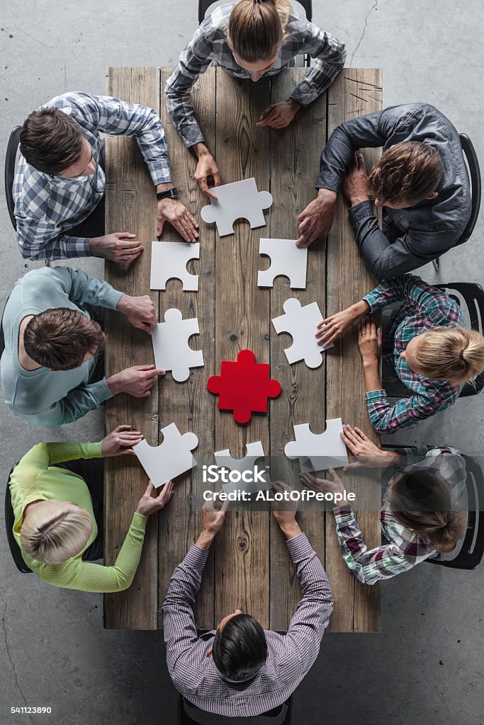 Teamwork meeting concept Hipster business successful teamwork concept, business group assembling jigsaw puzzle Teamwork Stock Photo