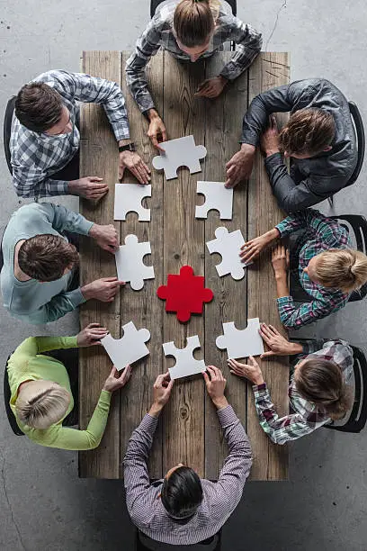 Hipster business successful teamwork concept, business group assembling jigsaw puzzle