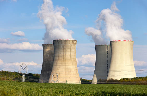 istock Nuclear power plant with green field. 541127490