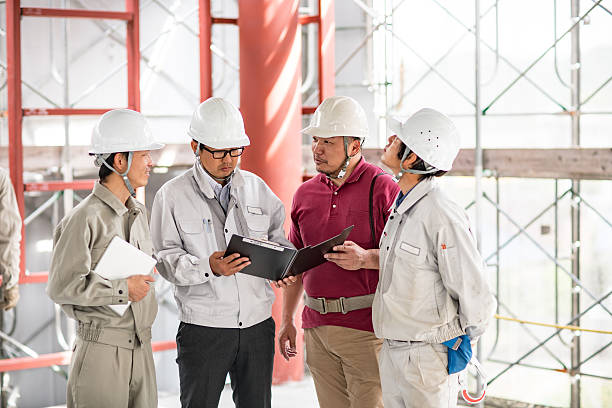 istock Four engineers having a meeting at building construction site 541127494