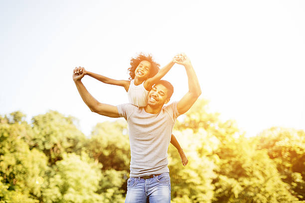 istock Father carrying daughter piggyback 541128188
