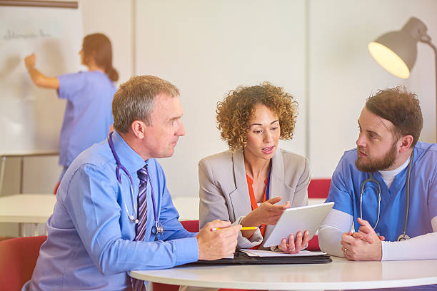 istock medical consultant with administrator 541128578