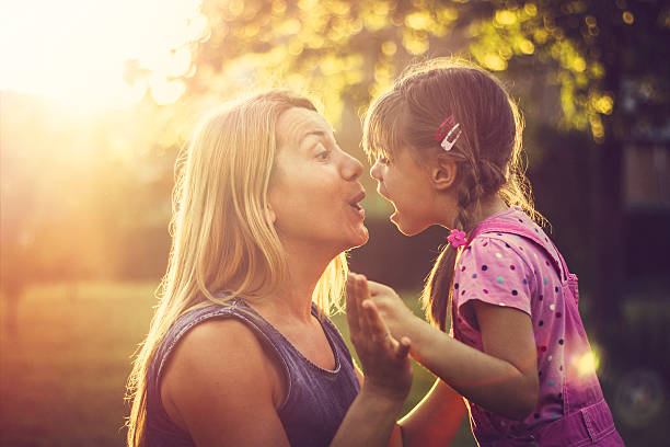 istock Happy family chatting outdoors at sunset 541130014